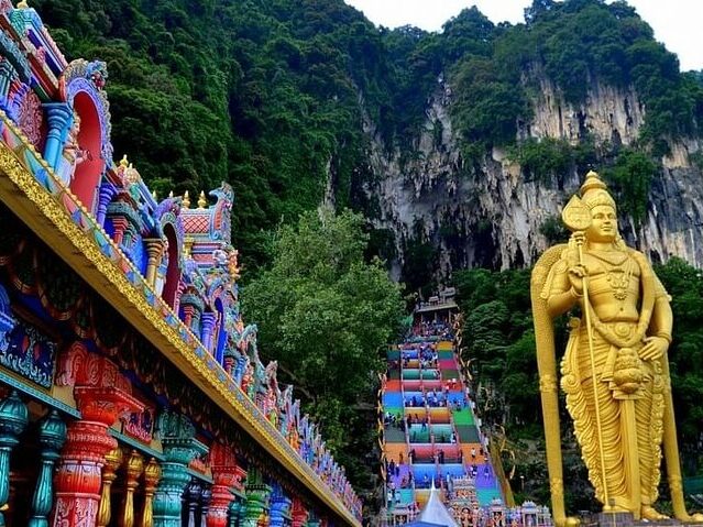 A guide to the Batu Caves dress code showing the colourful steps.