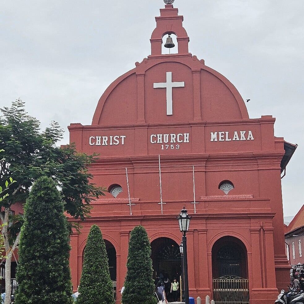 Christ Church Melaka at Melaka's Red Square on a cloudy day during a day trip by SGMY Private Tours.