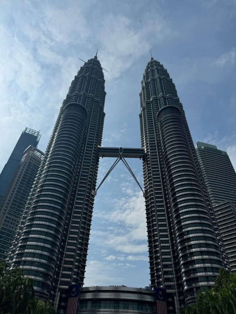 The Petronas Towers on a cloudy day, a highlight of a private tour to KL from Singapore.