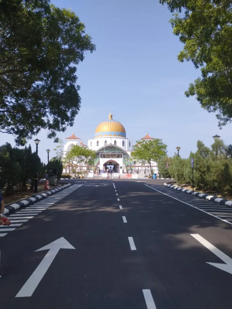 Melaka Straits Mosque entrance framed by trees