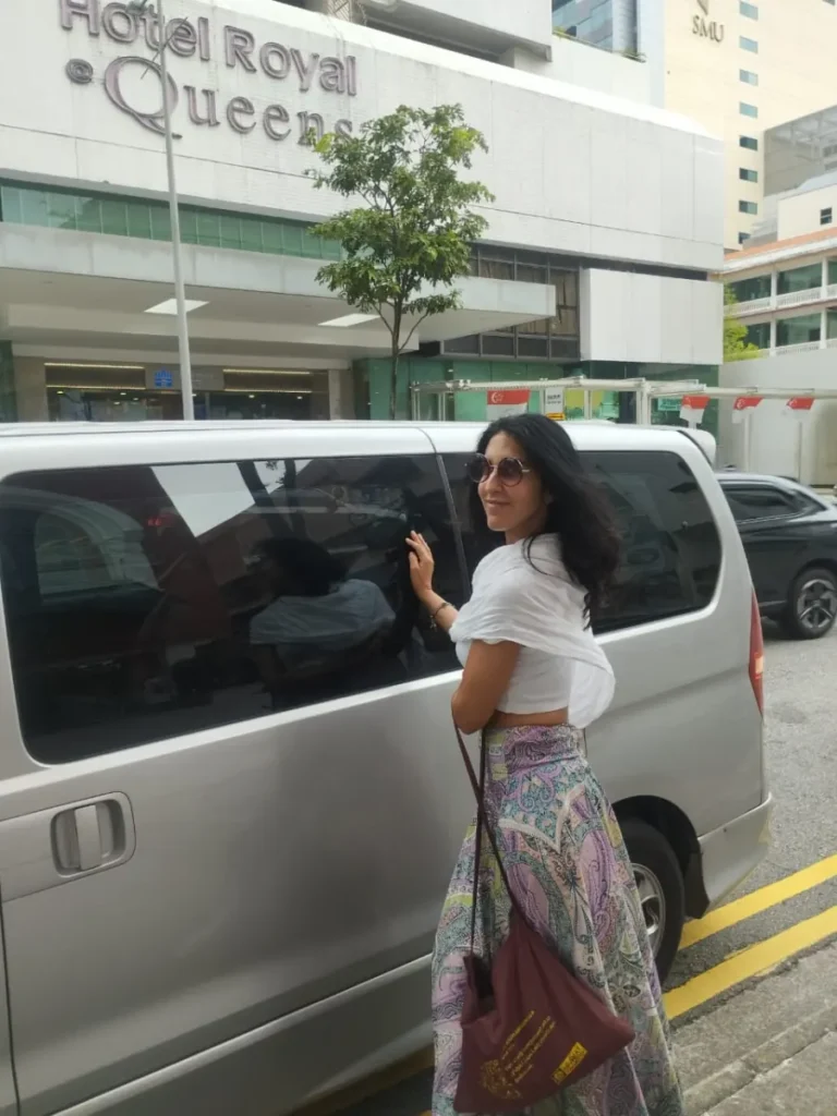 Traveller beside an example private tour vehicle at a Singapore hotel pickup